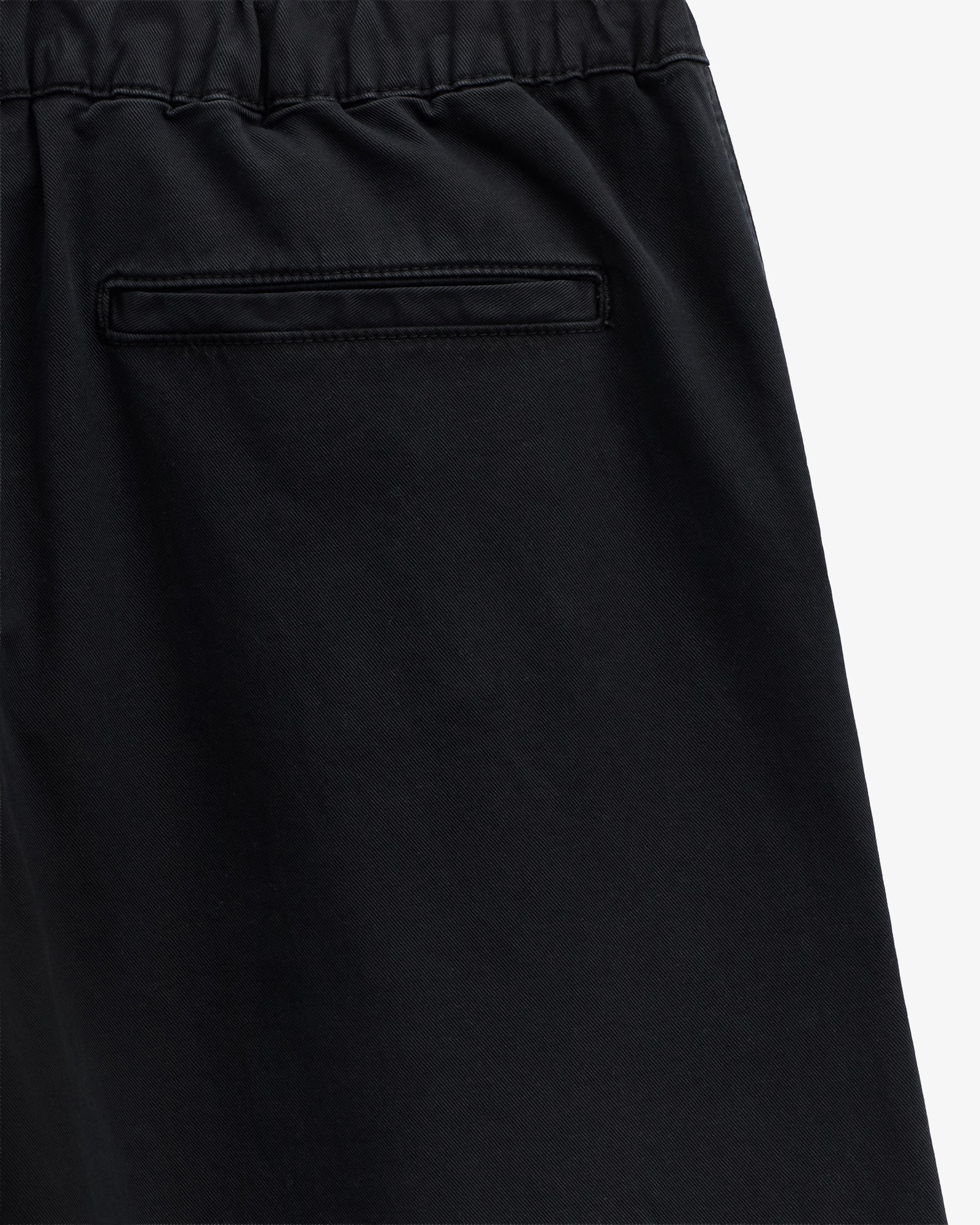 The Chamonix Chino in black — close-up of the back pocket and waistband