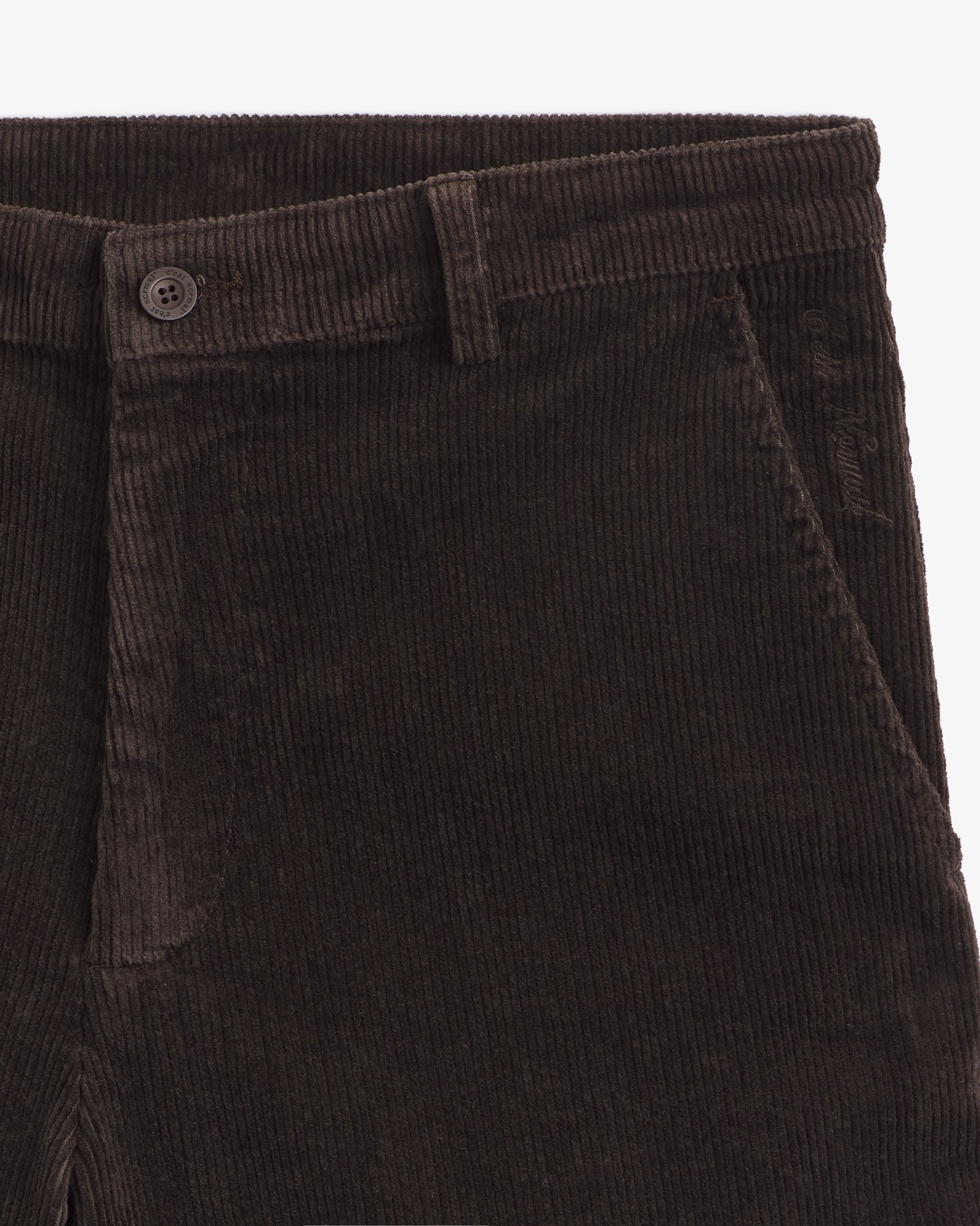 The Daily Cord Chino in chocolate — close-up of the waistband and pocket