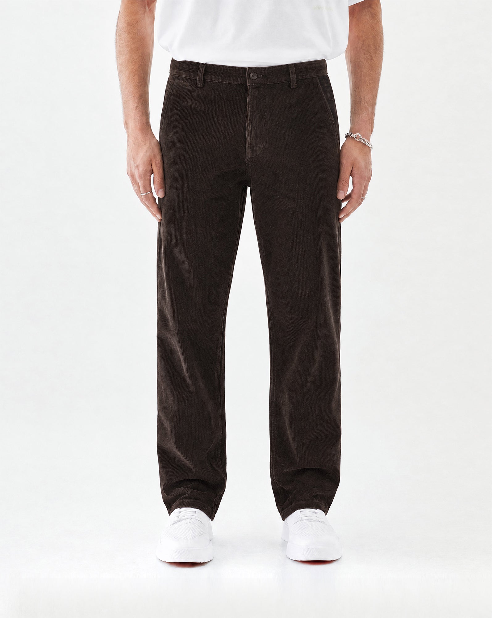 The Daily Cord Chino in chocolate — front view worn with white sneakers