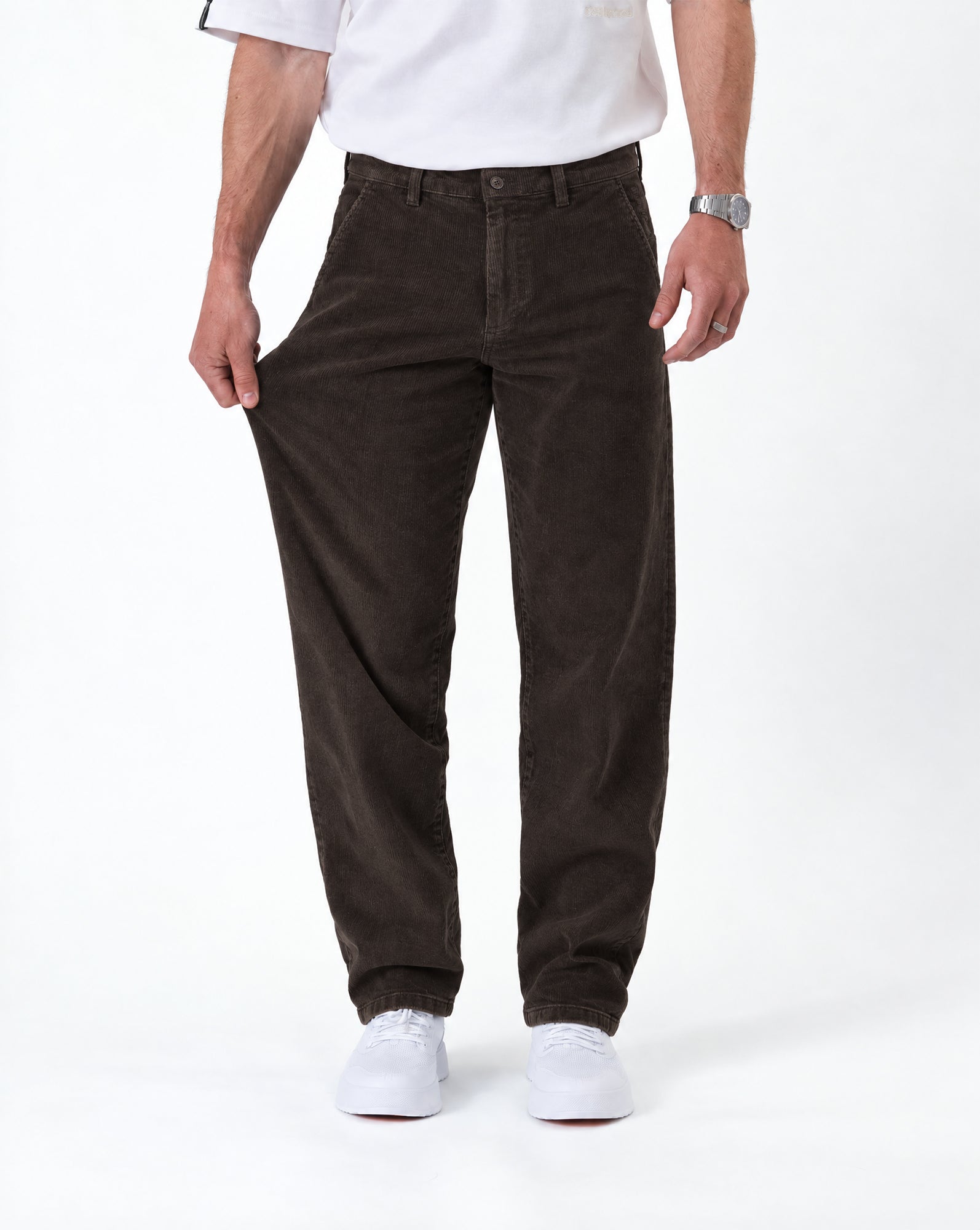 The Daily Cord Chino in chocolate — demonstrating stretch fabric