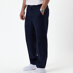 The Daily Linen Trouser in navy — side view showing the straight leg silhouette