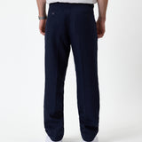 The Daily Linen Trouser in navy — back view showing the welt pockets and pressed crease