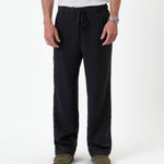 The Holiday Linen Trouser in black — front view with a drawstring waist
