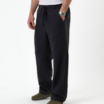 The Holiday Linen Trouser in black — front view against a white background