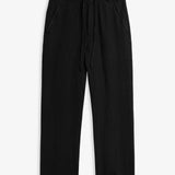 The Holiday Linen Trouser in black — front view showing the drawstring waistband