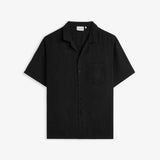 The Holiday Linen Resort Shirt in black — front view with a camp collar and chest pocket