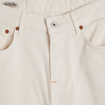 The Jeans Relaxed Straight Fit in ecru — close-up of the front button closure and rivets
