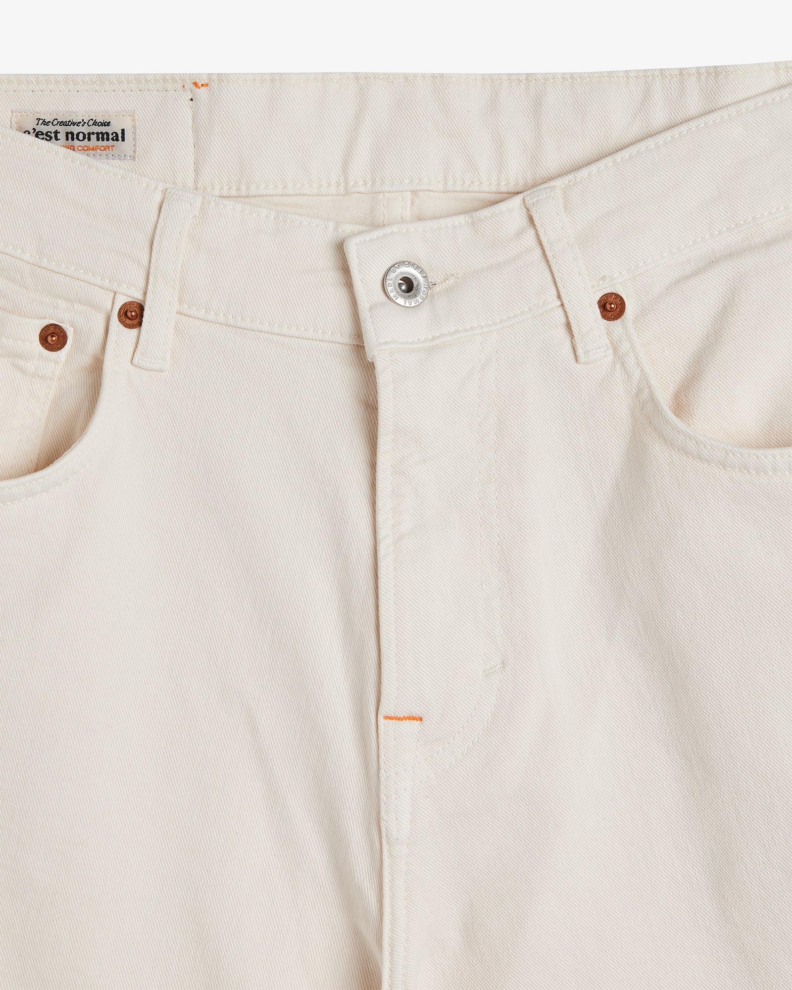 The Jeans Relaxed Straight Fit in ecru — close-up of the front button closure and rivets