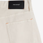 The Jeans Relaxed Straight Fit in ecru — back view with a black C'est normal rubber patch