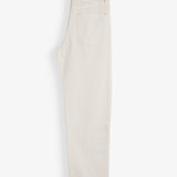 The Jeans Relaxed Straight Fit in ecru — folded back view with the C'est normal rubber patch