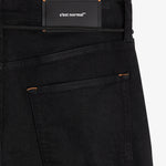 The Jeans Relaxed Straight Fit in jet black — back view with the black C'est normal rubber patch