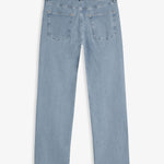 The Jeans Relaxed Straight Fit in Light Blue — back view with black C'est normal rubber patch