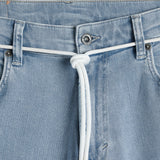 The Jeans Relaxed Straight Fit in light blue — closeup of the waist with branded hardware and a white cord belt