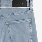 The Jeans Relaxed Straight Fit in light blue — back view with the black C'est normal rubber patch
