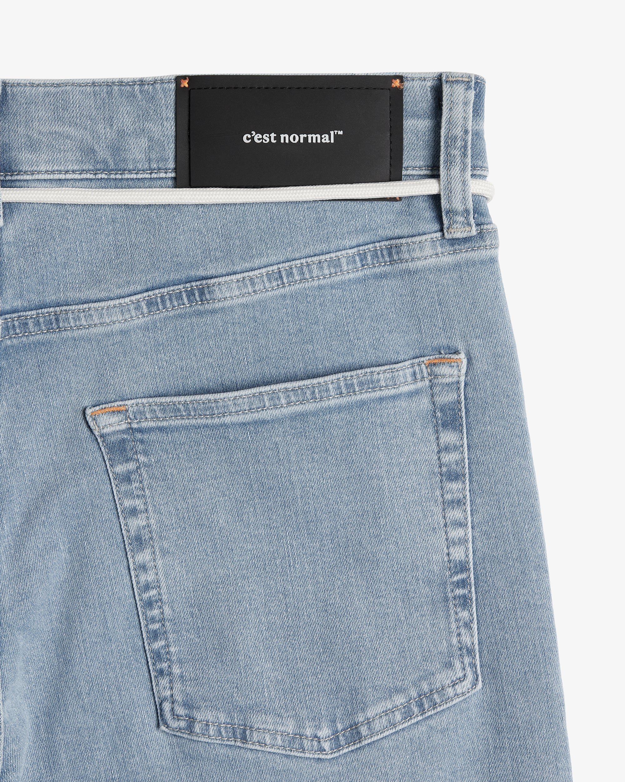 The Jeans Relaxed Straight Fit in light blue — back view with the black C'est normal rubber patch