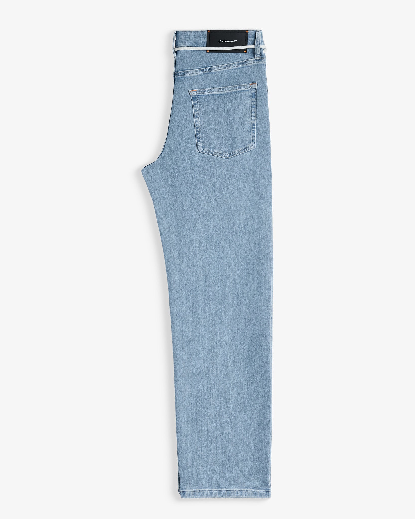 The Jeans Relaxed Straight Fit in light blue — folded view highlighting the back pocket and rubber patch