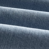 The Jeans Relaxed Straight Fit in light blue — close-up of the Motion Fabric texture