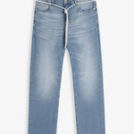 A front view of The Jeans Slim Fit in Light Midwash, laid flat on a white background. The image highlights the clean slim leg silhouette, subtle fade patterns, front pockets, zip fly with top button, and a white drawstring tied around the waist.