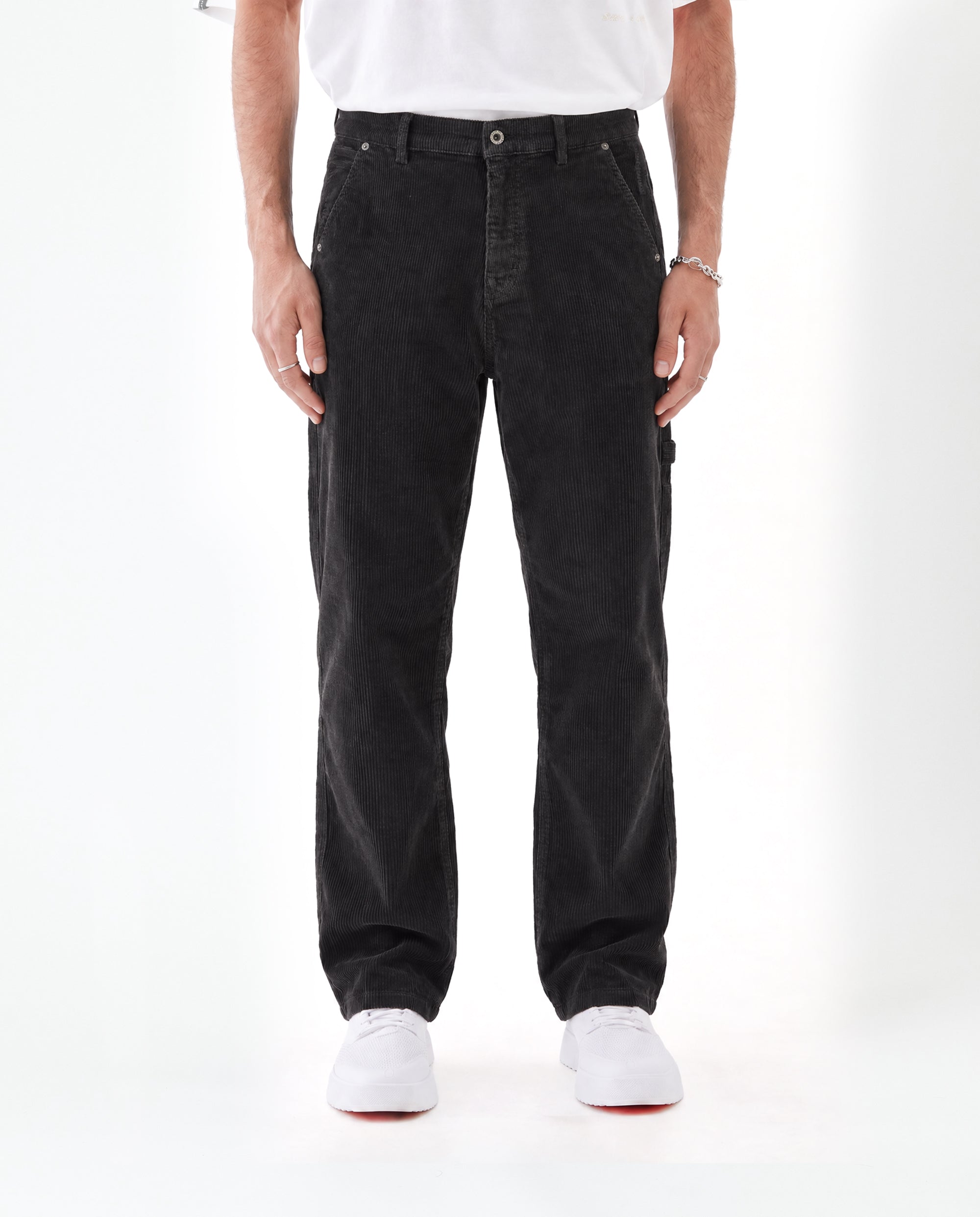 The Lille Cord Carpenter Pant in anthracite — front view worn with white sneakers