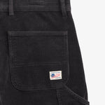 The Lille Cord Carpenter Pant in anthracite — close-up of the back pocket and logo label
