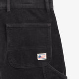 The Lille Cord Carpenter Pant in anthracite — close-up of the back pocket and logo label