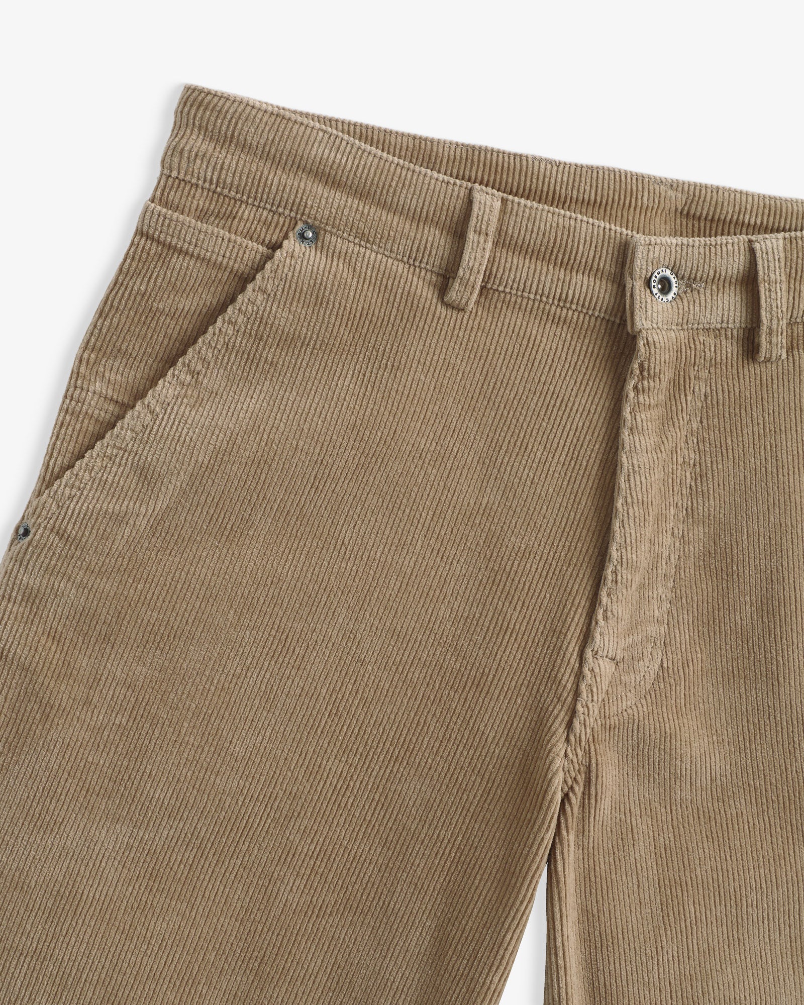 The Lille Cord Carpenter Pant in dark sand — close-up of the waistband and corduroy texture