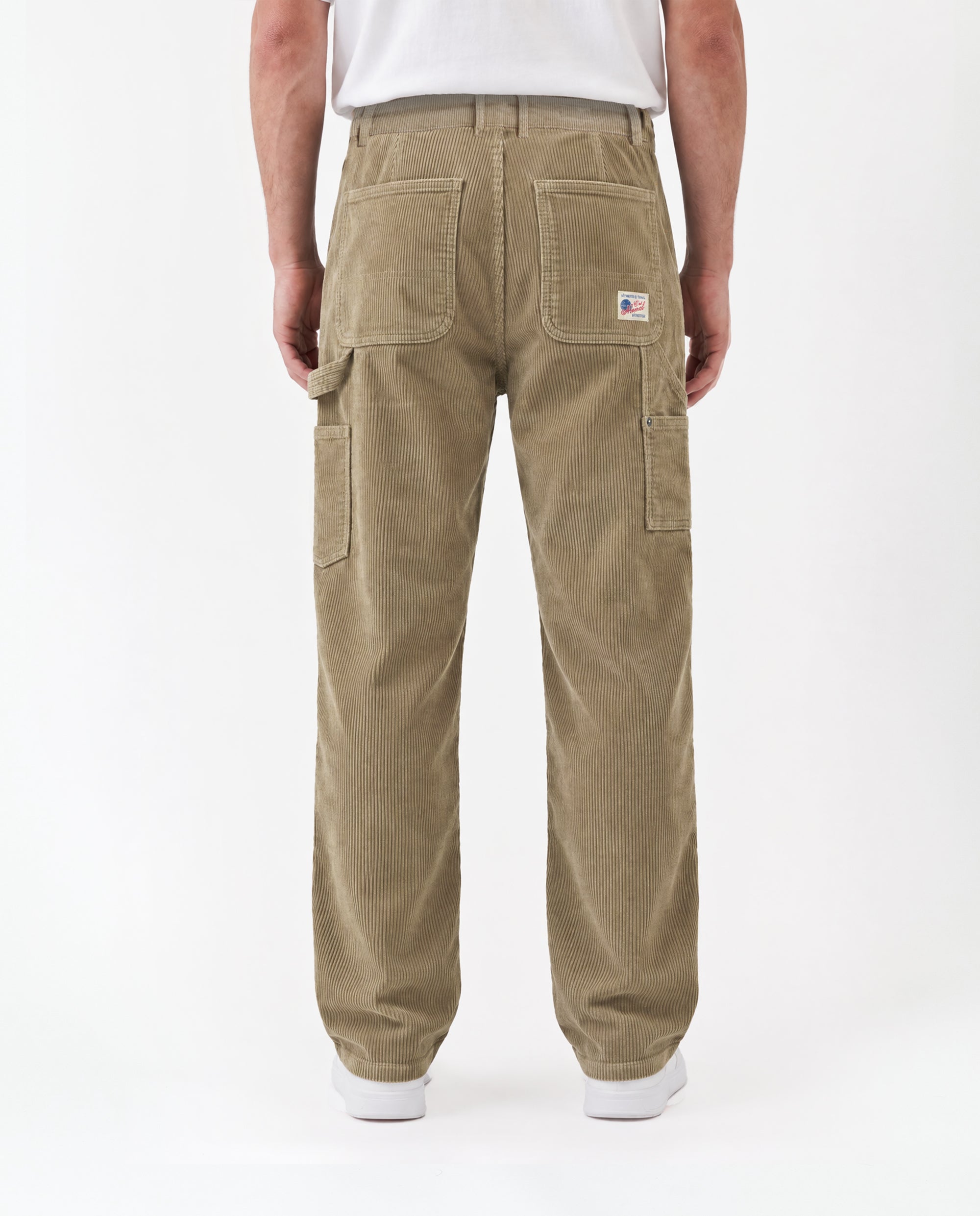 The Lille Cord Carpenter Pant in dark sand — back view showing patch pockets and hammer loop