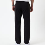 The Proper Pant Regular Fit in black — back view showing the rear welt pockets