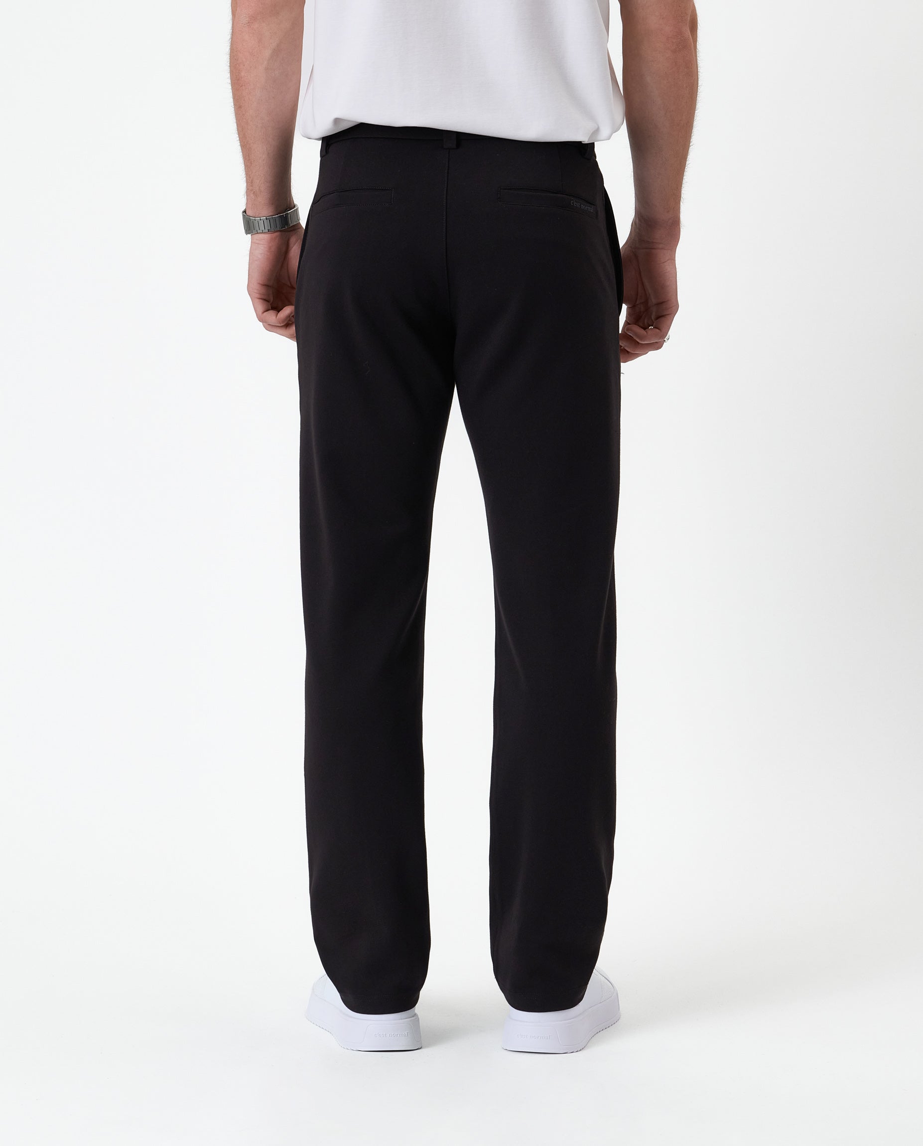 The Proper Pant Regular Fit in black — back view showing the rear welt pockets