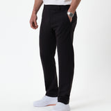 The Proper Pant Regular Fit in black — side view worn with white sneakers
