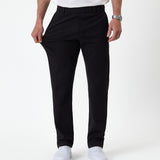 The Proper Pant Regular Fit in black — hand pulling the fabric to show its stretch