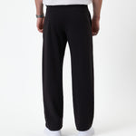 The Proper Pant Relaxed Straight Fit in black — back view showing the straight leg silhouette