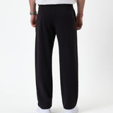 The Proper Pant Relaxed Straight Fit in black — back view showing the straight leg silhouette