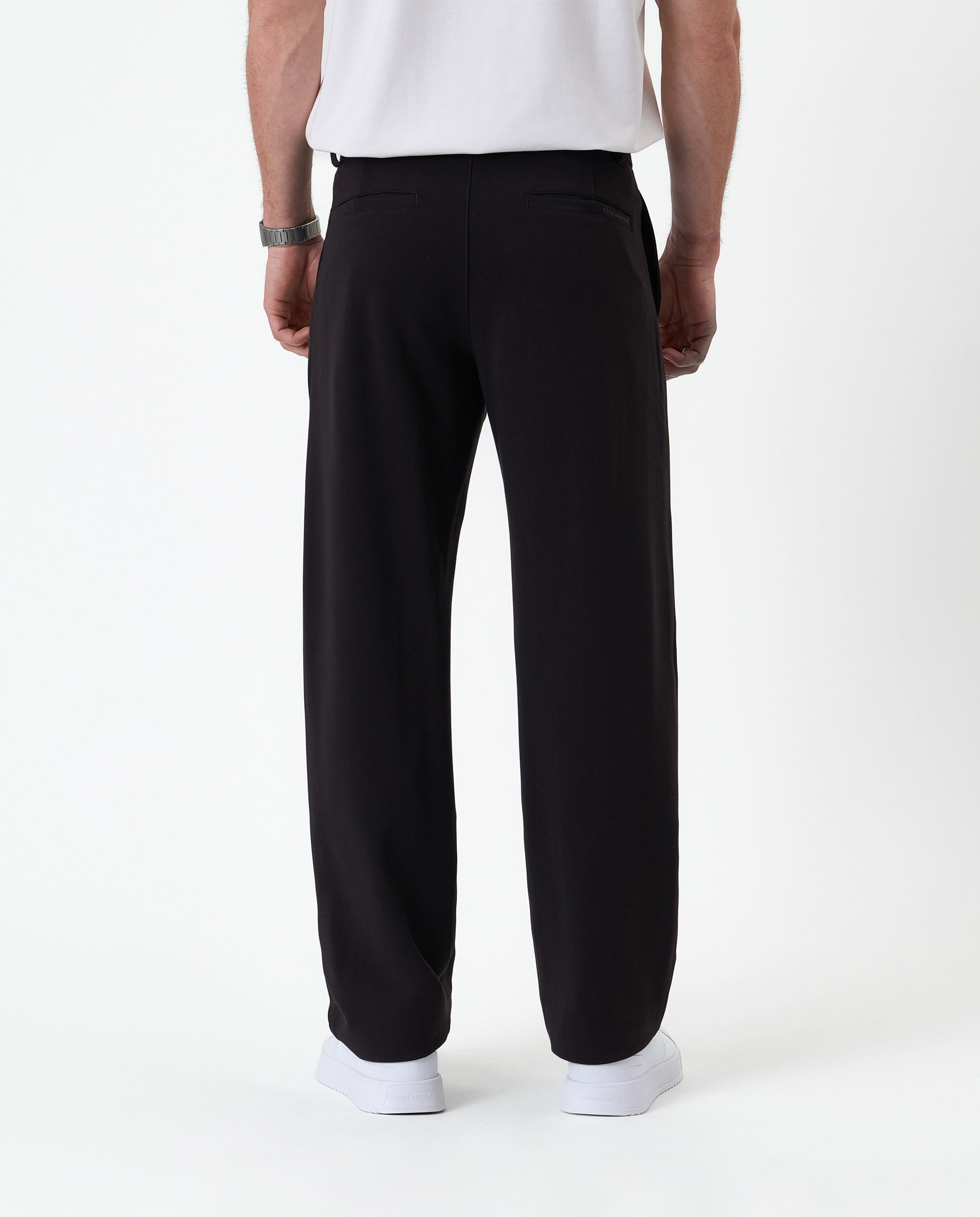 The Proper Pant Relaxed Straight Fit in black — back view showing the straight leg silhouette
