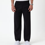 The Proper Pant Relaxed Straight Fit in black — front view worn with white sneakers