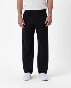 The Proper Pant Relaxed Straight Fit in black — front view worn with white sneakers