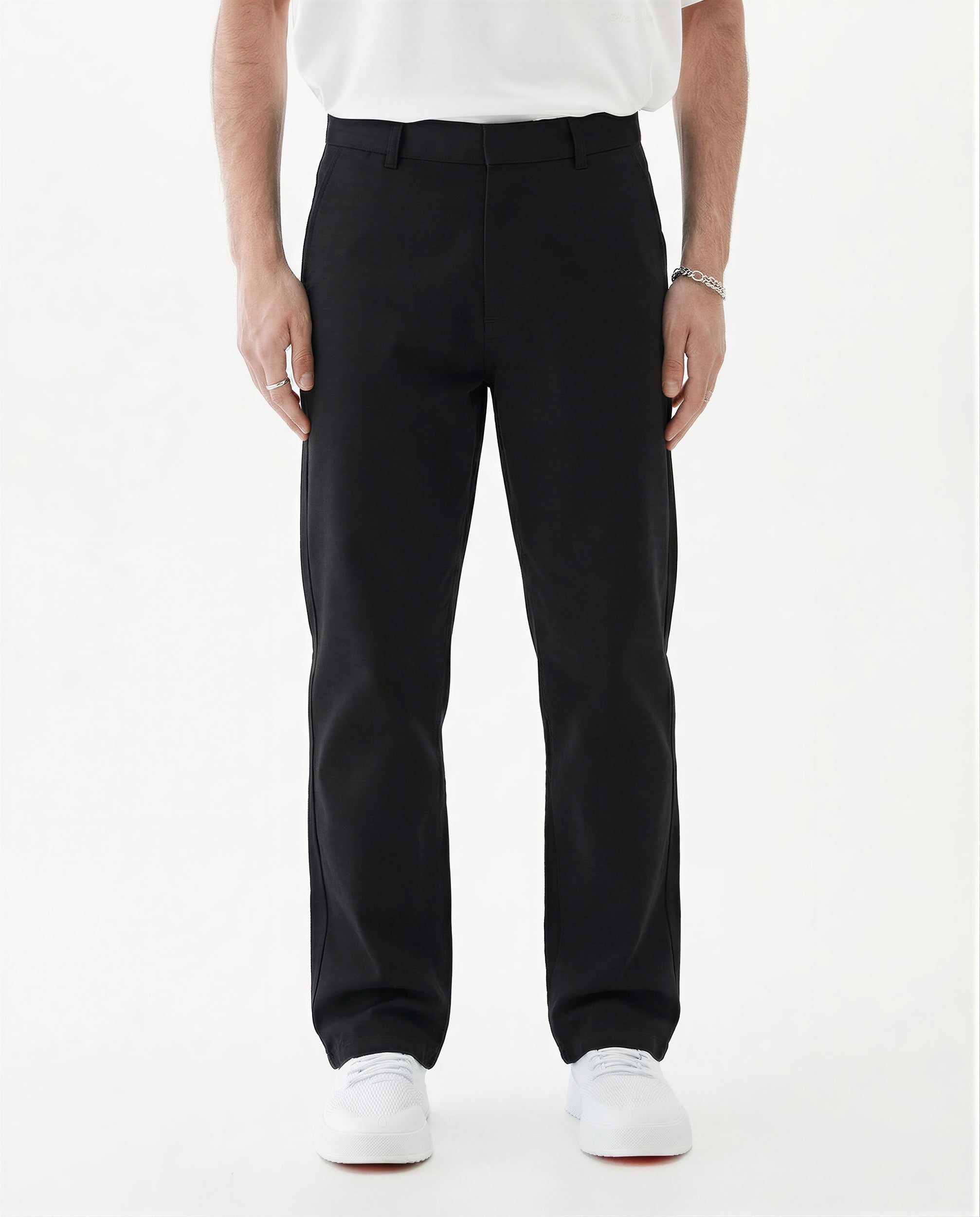 The Proper Pant Relaxed Straight Fit in black — worn with white sneakers