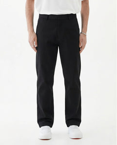 The Proper Pant Relaxed Straight Fit in black — worn with white sneakers