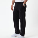 The Proper Pant Relaxed Straight Fit in black — side view styled with white sneakers
