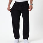 The Proper Pant Relaxed Straight Fit in black — pulling the fabric to show the stretch