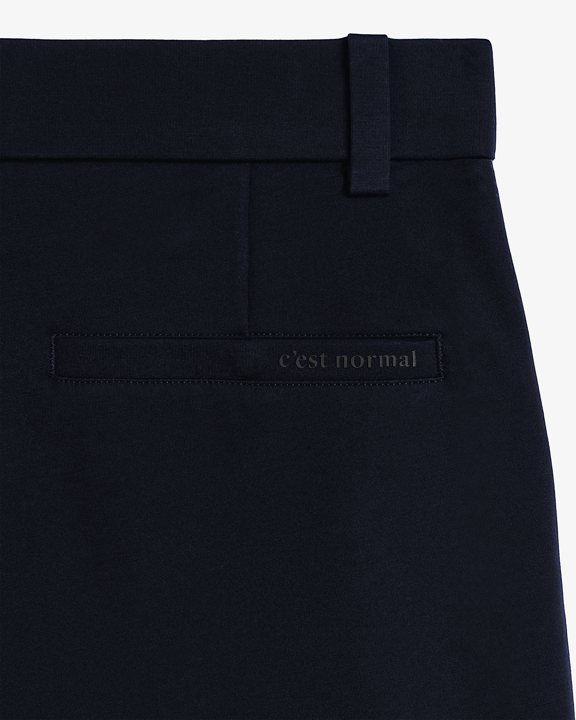 The Proper Pant Relaxed Straight Fit in navy — back pocket with C'est normal logo.