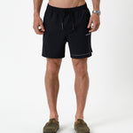 The Shorts in black — front view featuring the white C'est normal logo