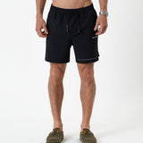 The Shorts in black — front view featuring the white C'est normal logo