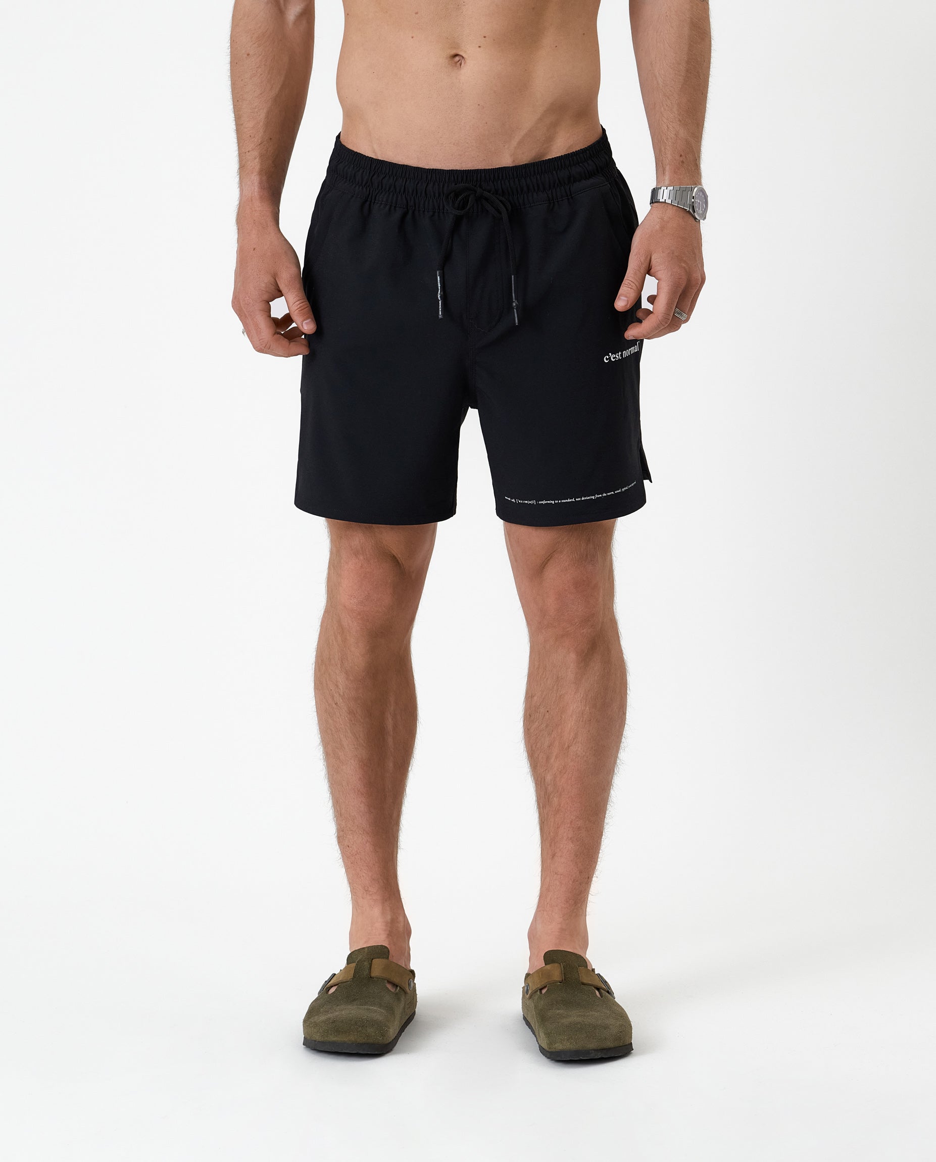 The Shorts in black — front view featuring the white C'est normal logo