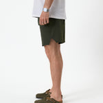The Shorts in khaki — side view showing the notched hem and athletic fit