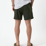 The Shorts in khaki — back view showing the pocket detail and notched hem