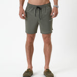 The Shorts in mulled green — front view with white C'est normal logo