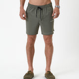 The Shorts in mulled green — front view with white C'est normal logo