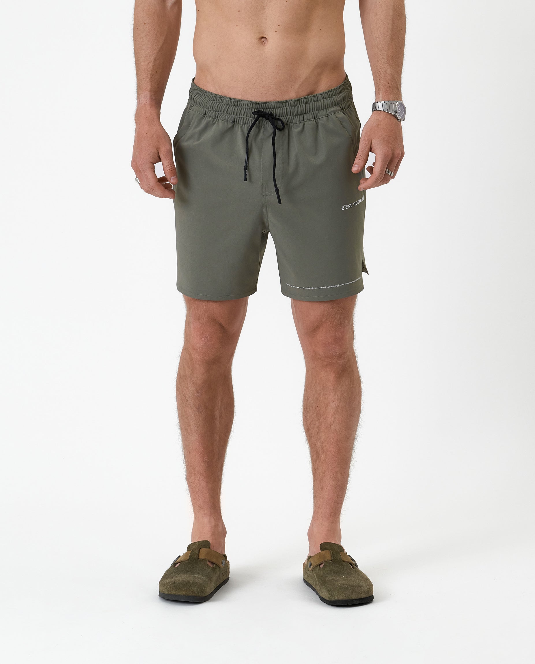The Shorts in mulled green — front view with white C'est normal logo