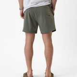 The Shorts in mulled green — back view showing the rear pocket and notched hem